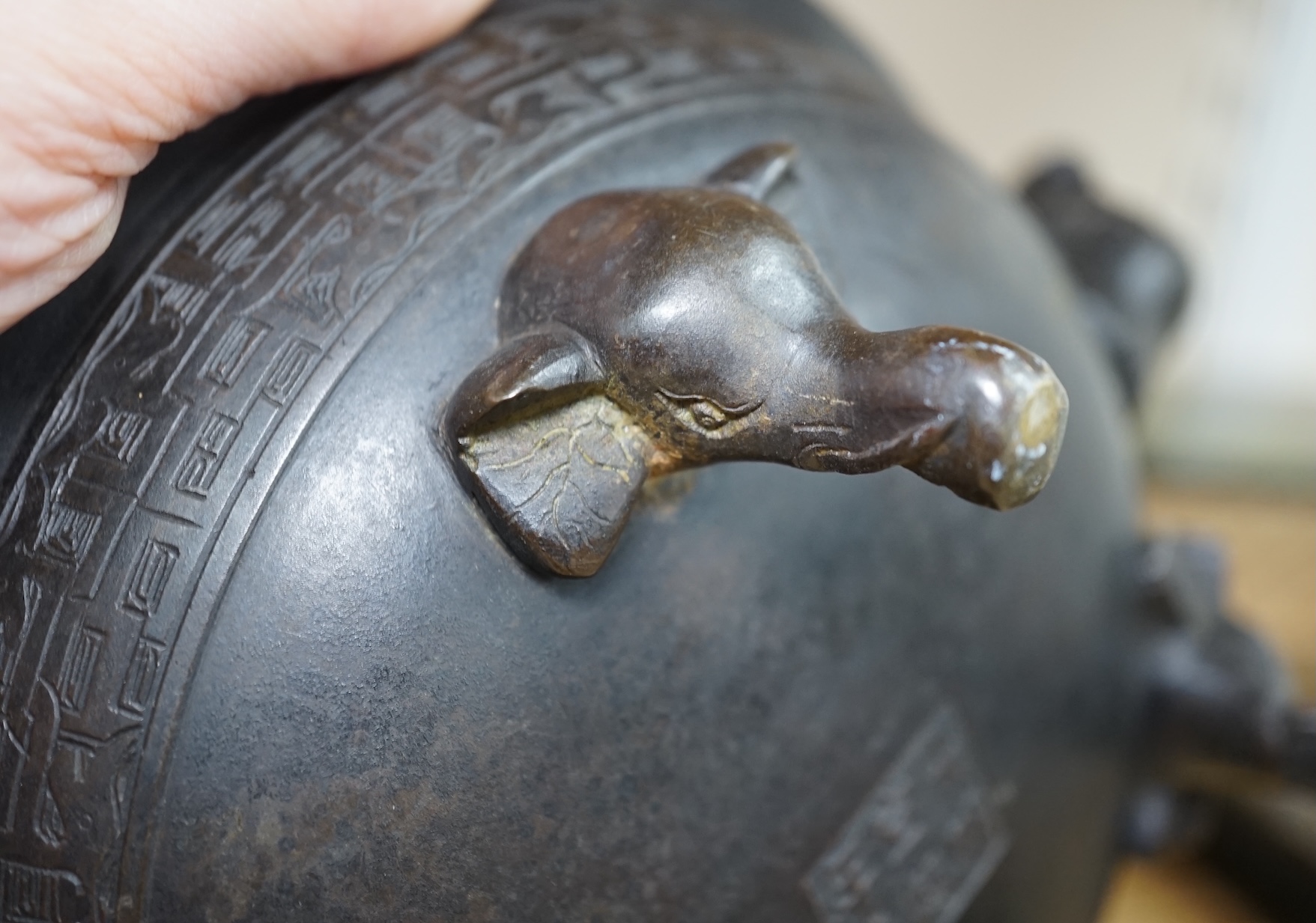 A Chinese archaistic bronze tripod ‘elephant head’ censer, Xuande mark, 19th century, 24cm handle to handle. Condition - fair to good